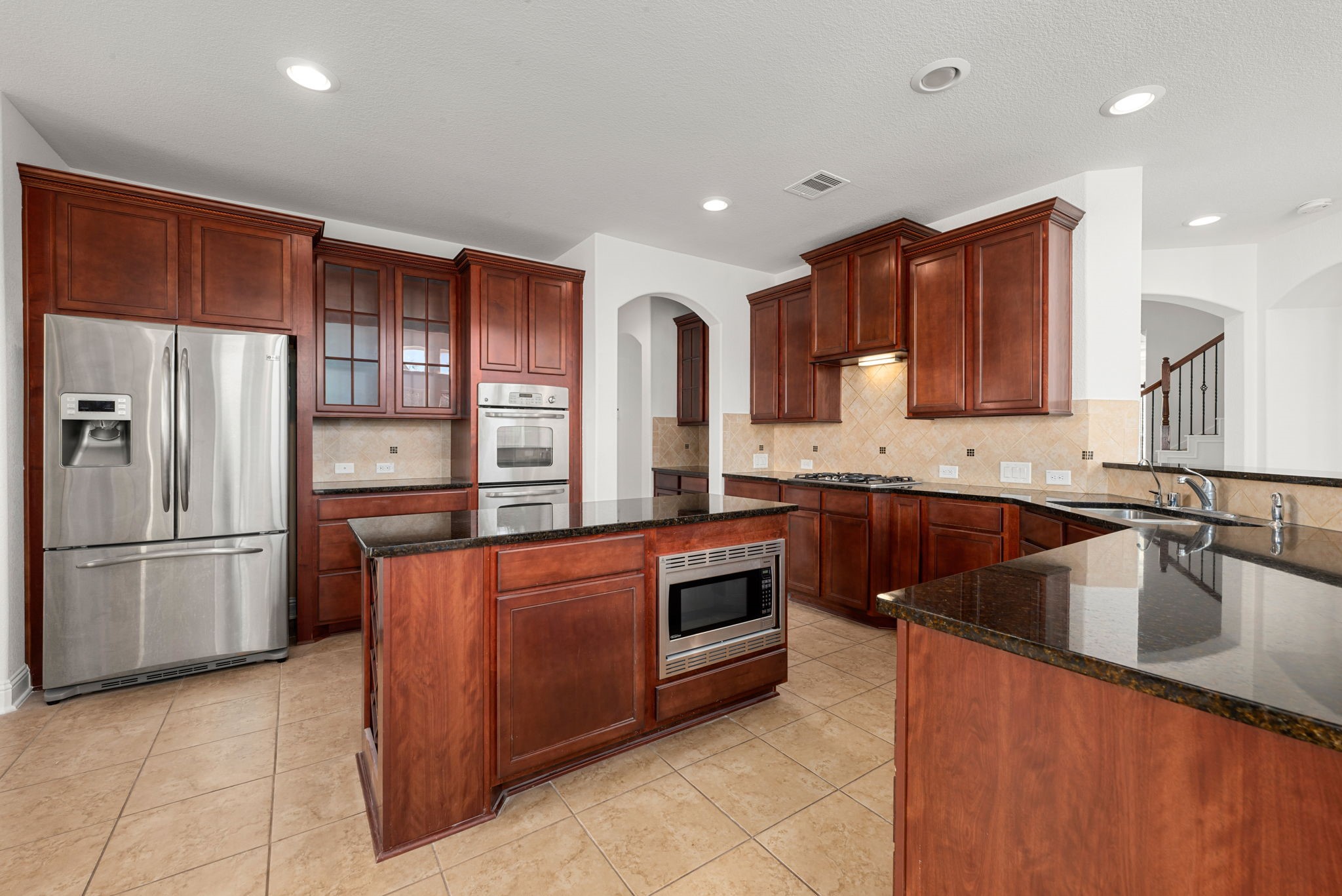 22719 Shieldhall Lane Tomball, TX 77375 - Photo 14 of 49 a kitchen with stainless steel appliances granite countertop a refrigerator a sink a stove a microwave and island