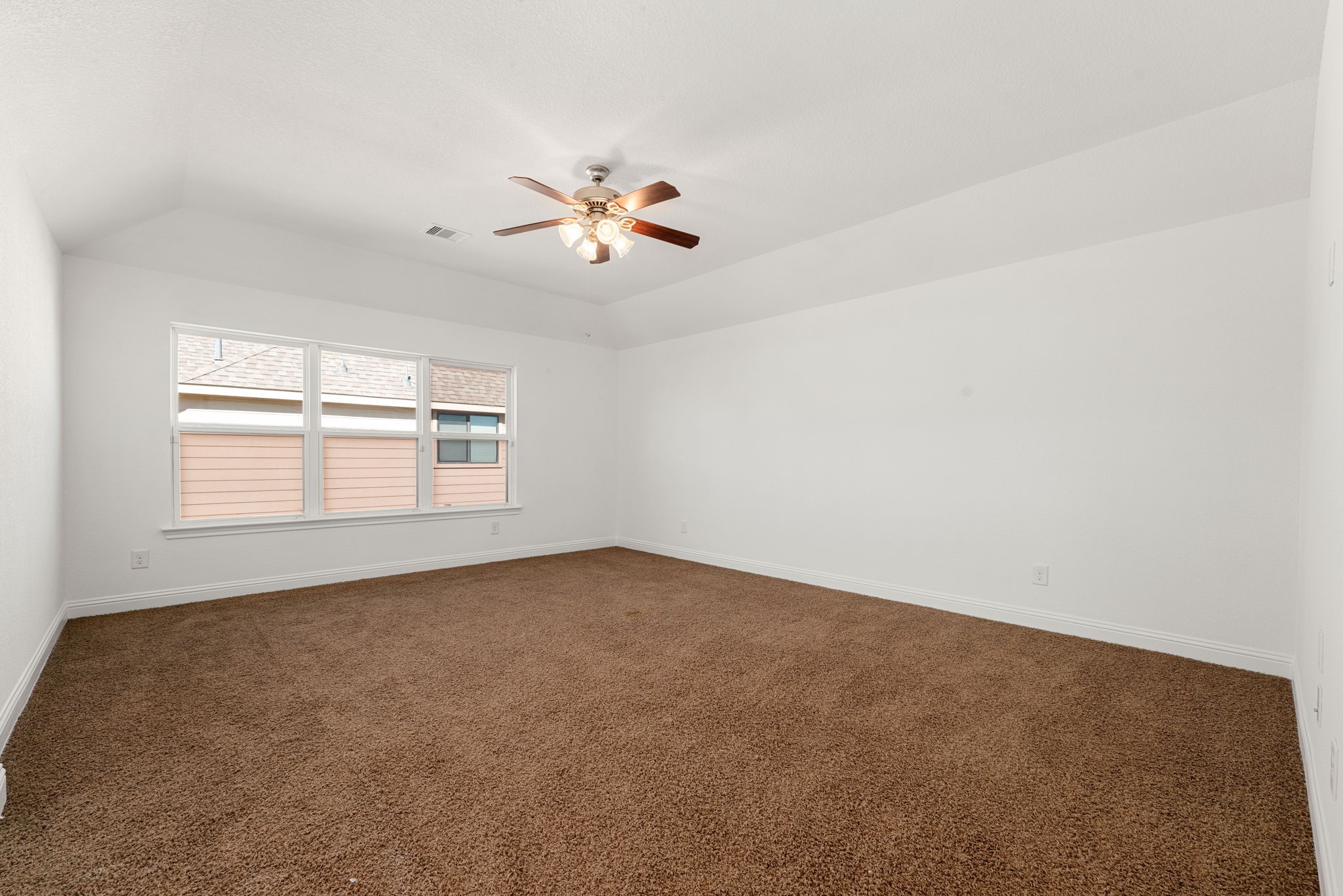 22719 Shieldhall Lane Tomball, TX 77375 - Photo 31 of 49 an empty room with a window and a ceiling fan