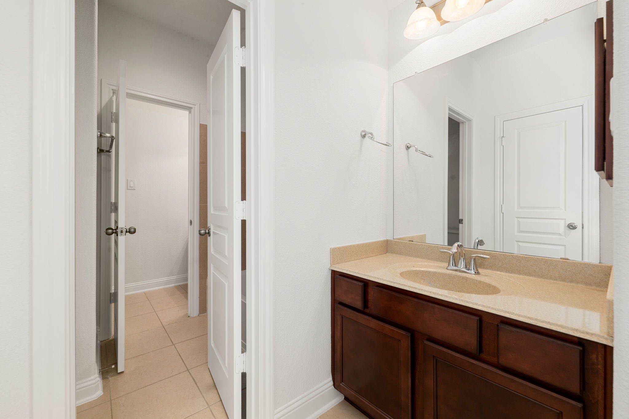 22719 Shieldhall Lane Tomball, TX 77375 - Photo 36 of 49 a bathroom with a sink and a mirror