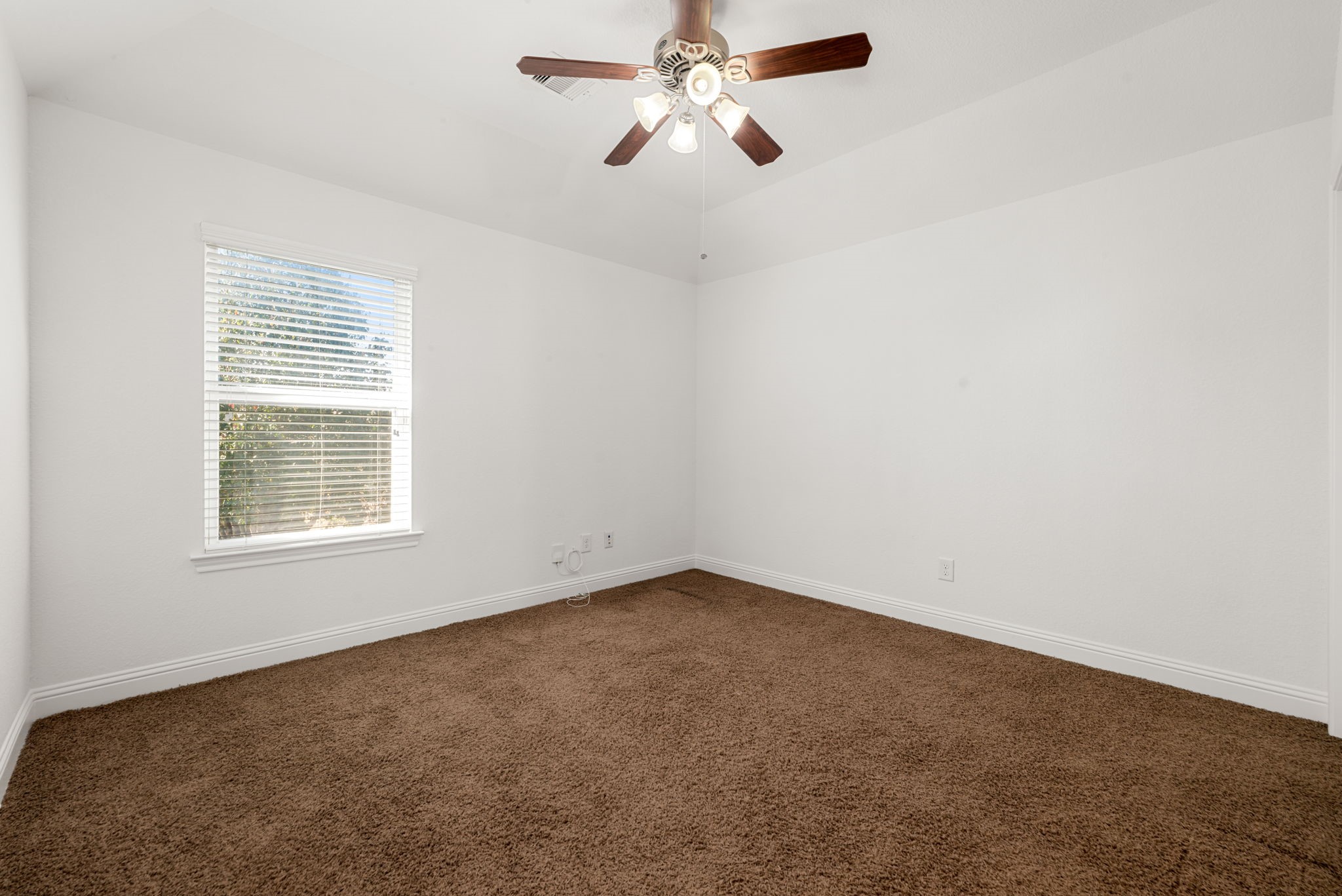 22719 Shieldhall Lane Tomball, TX 77375 - Photo 38 of 49 an empty room with a window and a fan