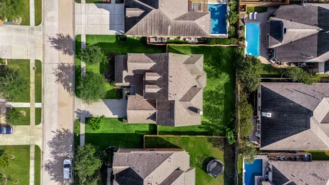 an aerial view of a house with a garden and lake view