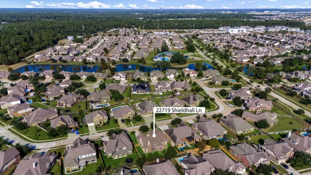 an aerial view of residential houses with outdoor space