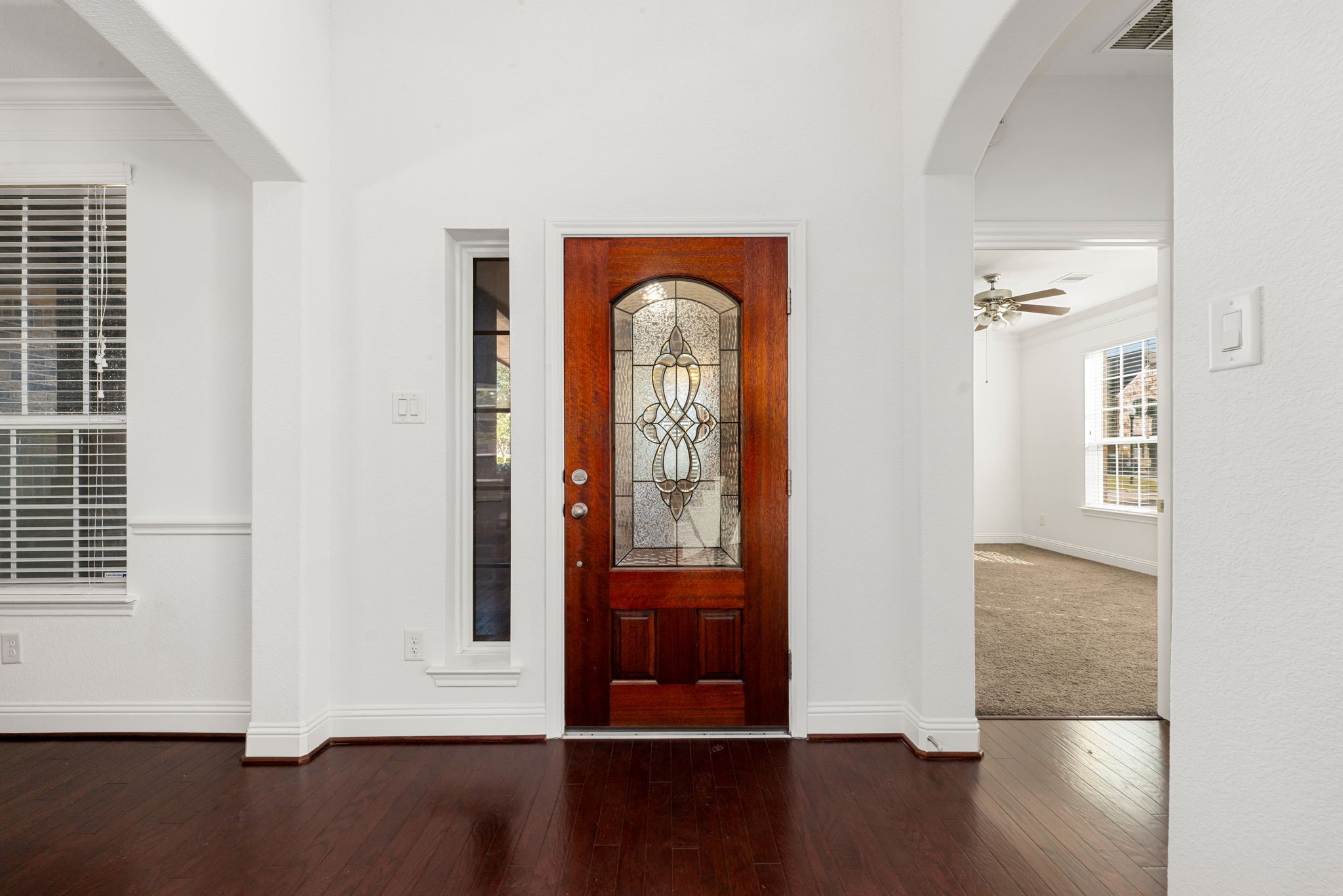 22719 Shieldhall Lane Tomball, TX 77375 - Photo 5 of 49 an empty room with wooden floor mirror and windows