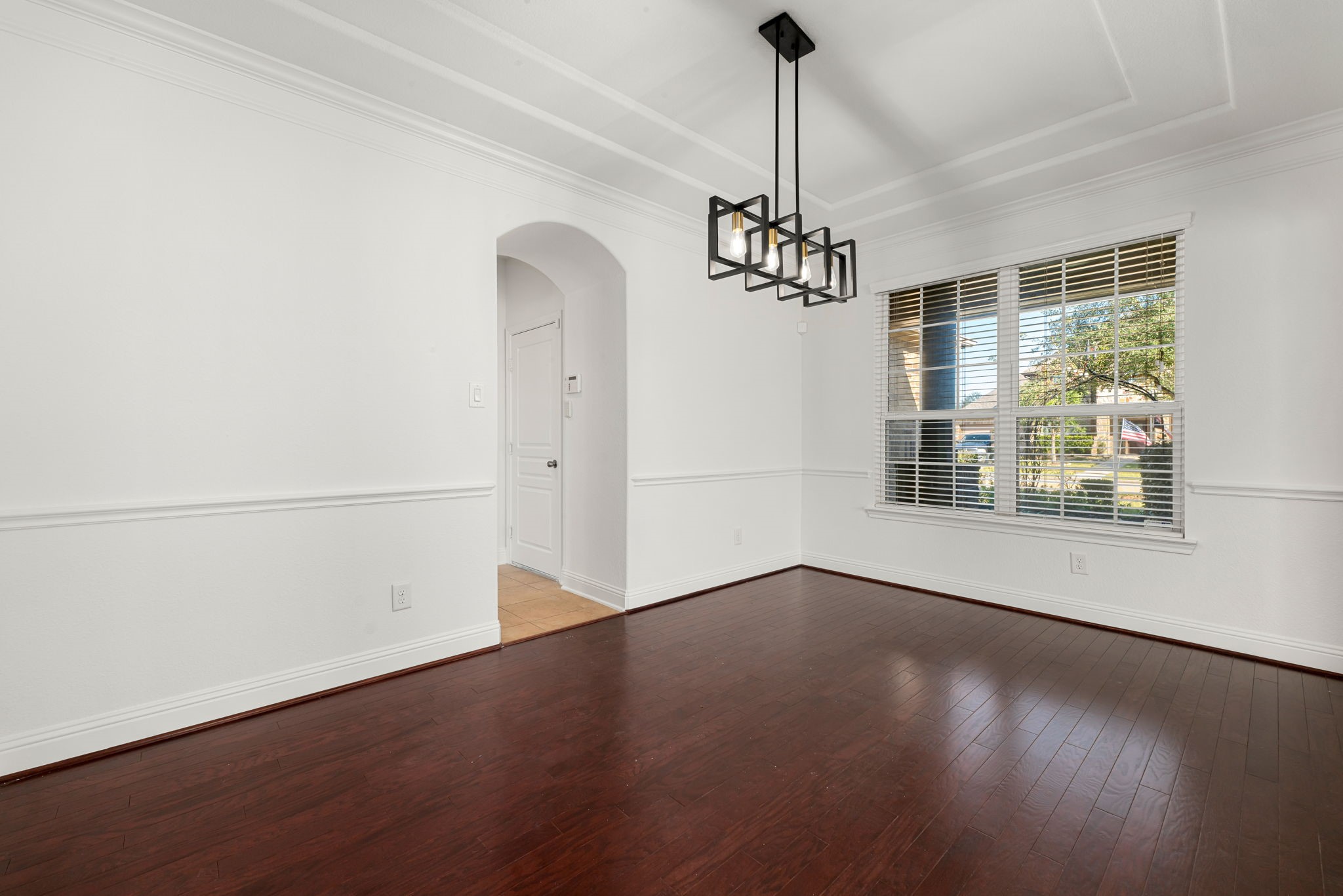 22719 Shieldhall Lane Tomball, TX 77375 - Photo 7 of 49 a view of a room with wooden floor chandelier and windows