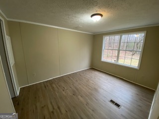 1368 Dee Kennedy Road Auburn, GA 30011 - Photo 13 of 15 an empty room with wooden floor and windows
