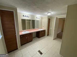 a bathroom with a double vanity sink a mirror and a bathtub