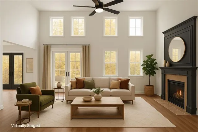 an empty room with windows and fireplace