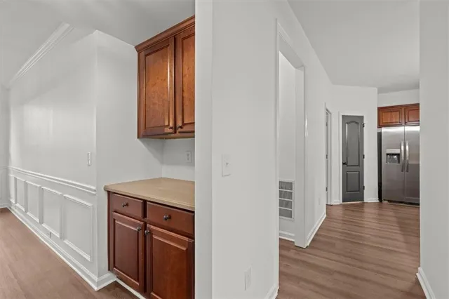 a view of a livingroom with wooden floor and a ceiling fan