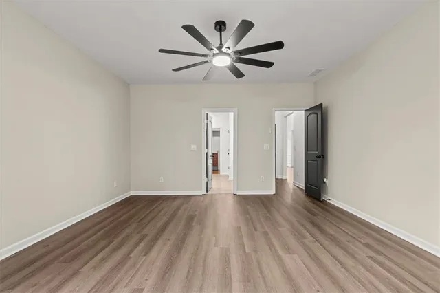 a view of a livingroom with wooden floor and stairs