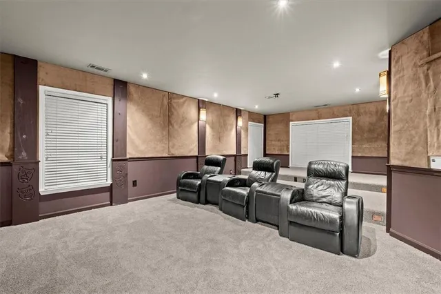 an empty room with window and ceiling fan