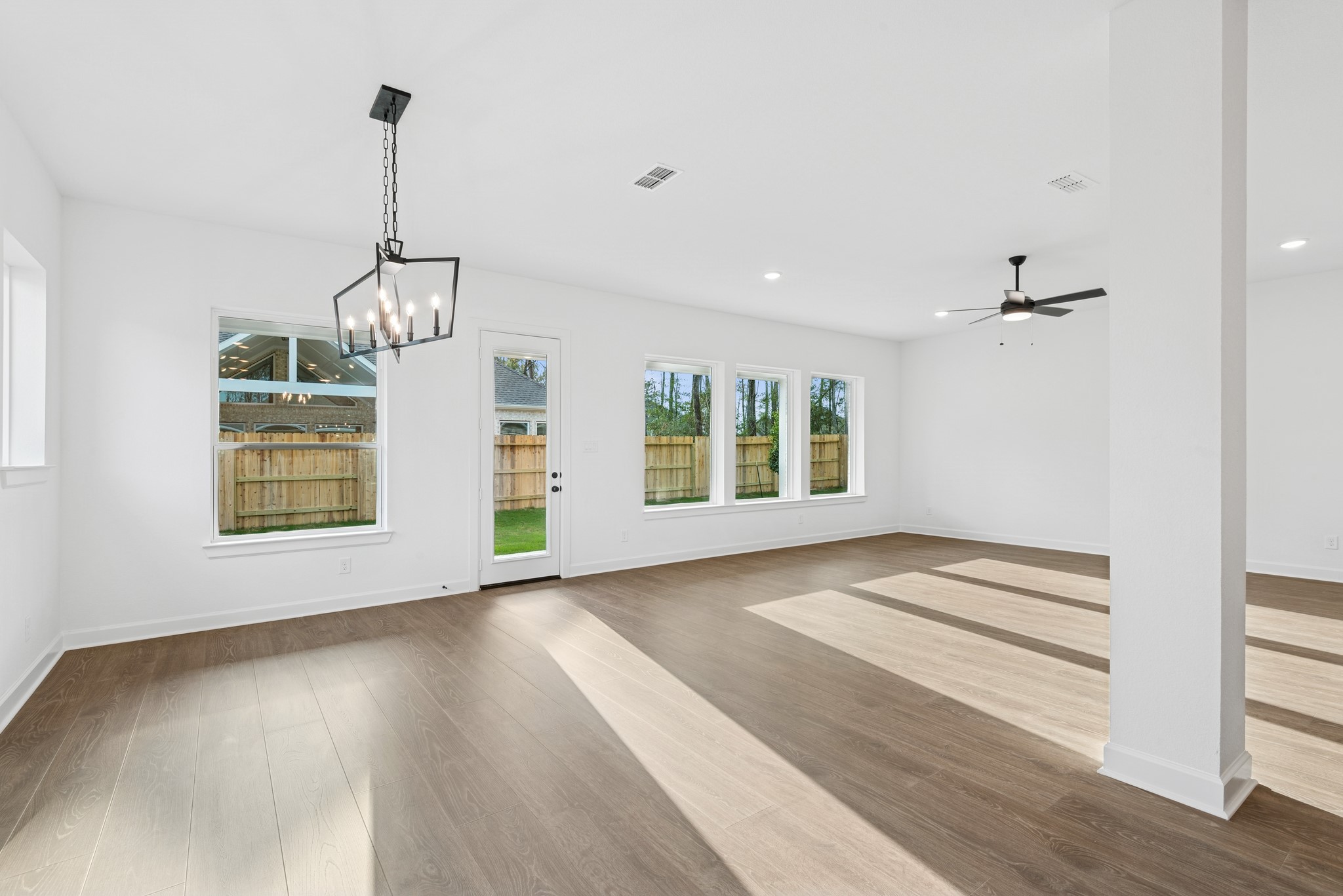 15714 Terracotta Terrace Lane Conroe, TX 77302 - Photo 30 of 47 a view of an empty room with window and wooden floor