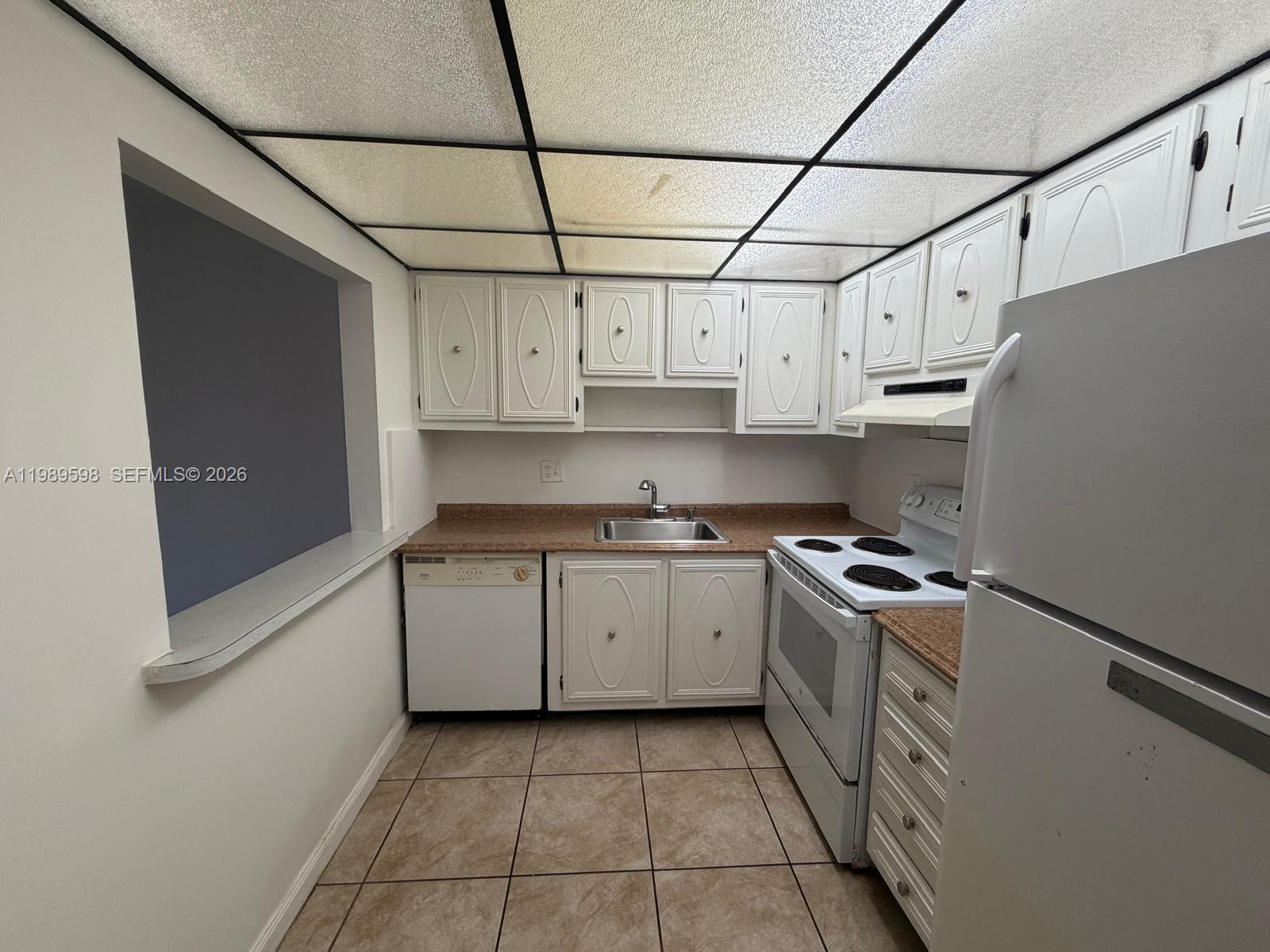 253 South Cypress Road, Unit 214 Pompano Beach, FL 33060 - Photo 2 of 25 a kitchen with stainless steel appliances granite countertop a stove and a refrigerator