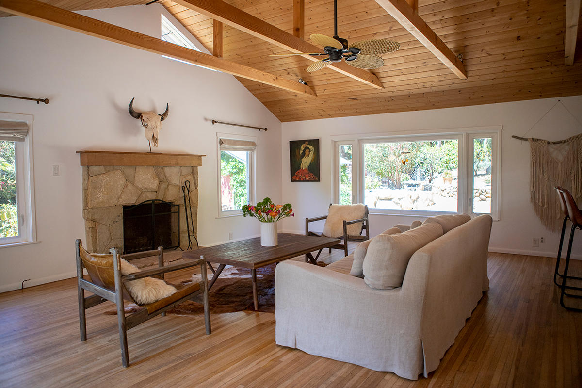 a living room with furniture a fireplace and a table