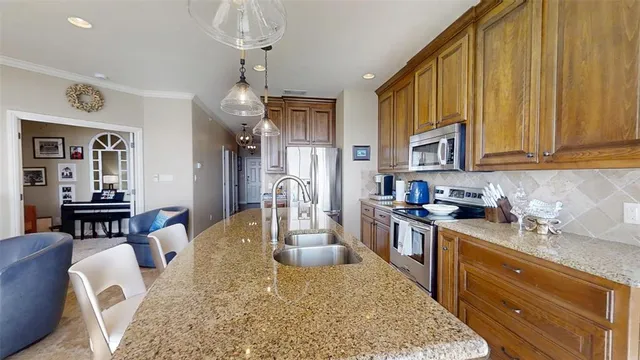 a kitchen with a table chairs stove and refrigerator