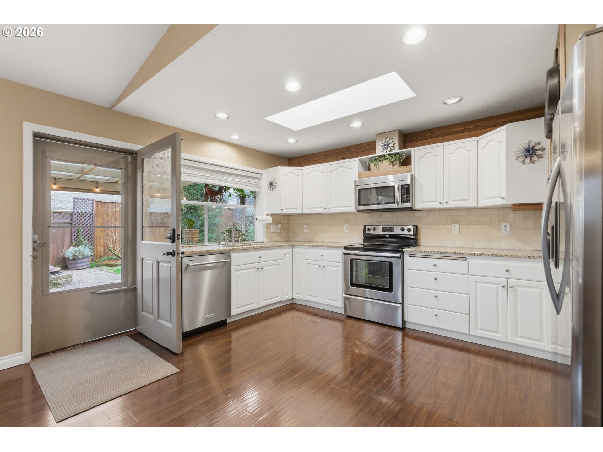 1315 High Street Gladstone, OR 97027 - Photo 14 of 36 a kitchen with granite countertop white cabinets and stainless steel appliances
