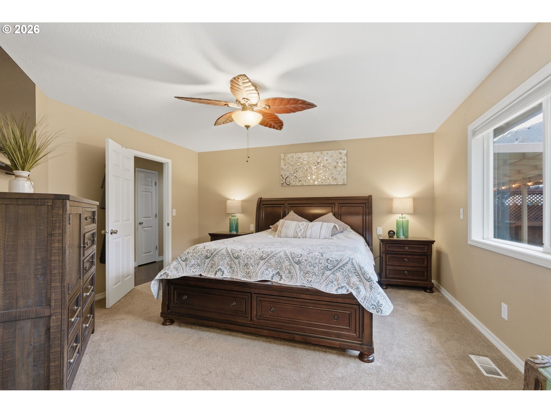 1315 High Street Gladstone, OR 97027 - Photo 17 of 36 a spacious bedroom with a bed and a chandelier