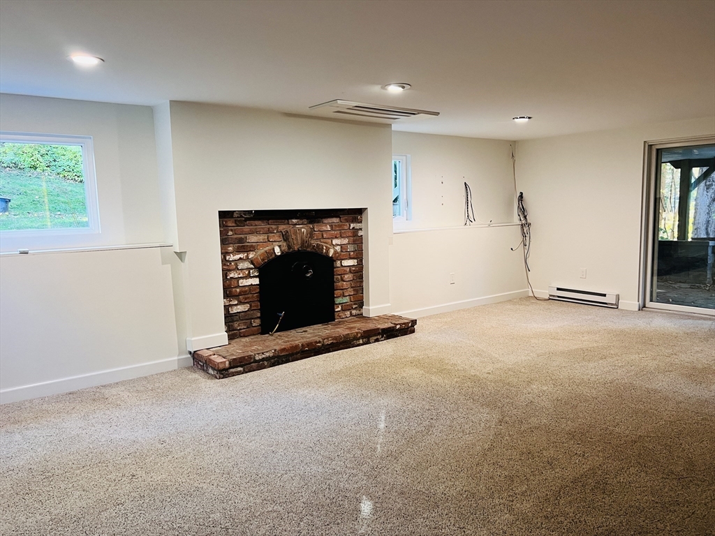 135 Walker Pond Road Sturbridge, MA 01566 - Photo 11 of 16 a view of an empty room with a fireplace