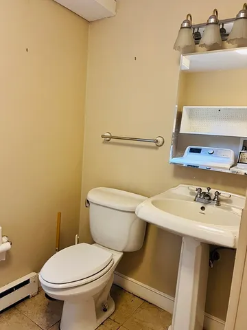 a bathroom with a sink a toilet and a mirror