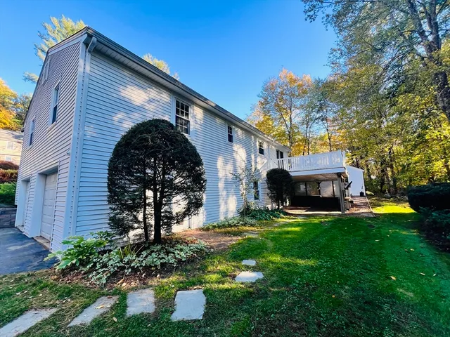 a view of a house with a backyard and a patio