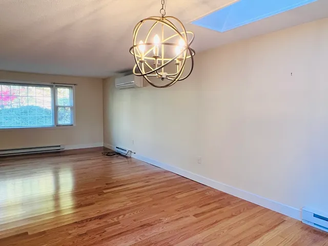 a view of a room with wooden floor and a window