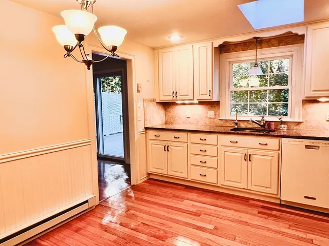 a kitchen with granite countertop a sink cabinets and a window