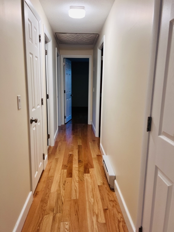 135 Walker Pond Road Sturbridge, MA 01566 - Photo 5 of 16 a view of a hallway with wooden floor and staircase