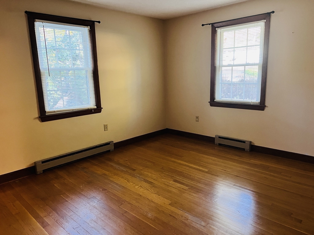 135 Walker Pond Road Sturbridge, MA 01566 - Photo 8 of 16 a view of an empty room with wooden floor and a window