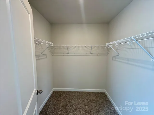 a en suite bathroom with a double vanity sink toilet and mirror