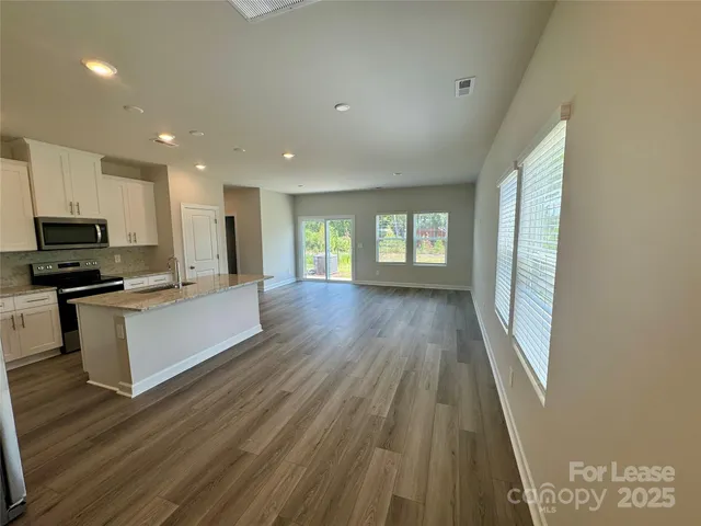 a view of kitchen with sink and wooden floor