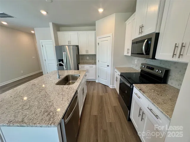 a kitchen with a sink stove and refrigerator