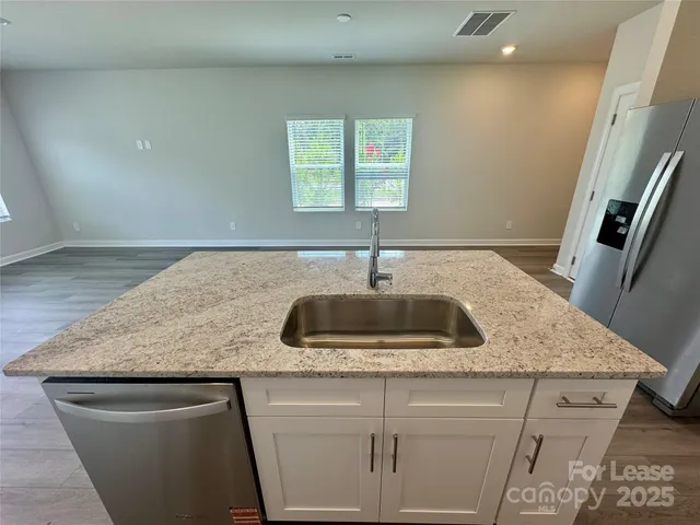 a kitchen with a sink a counter top space and a window