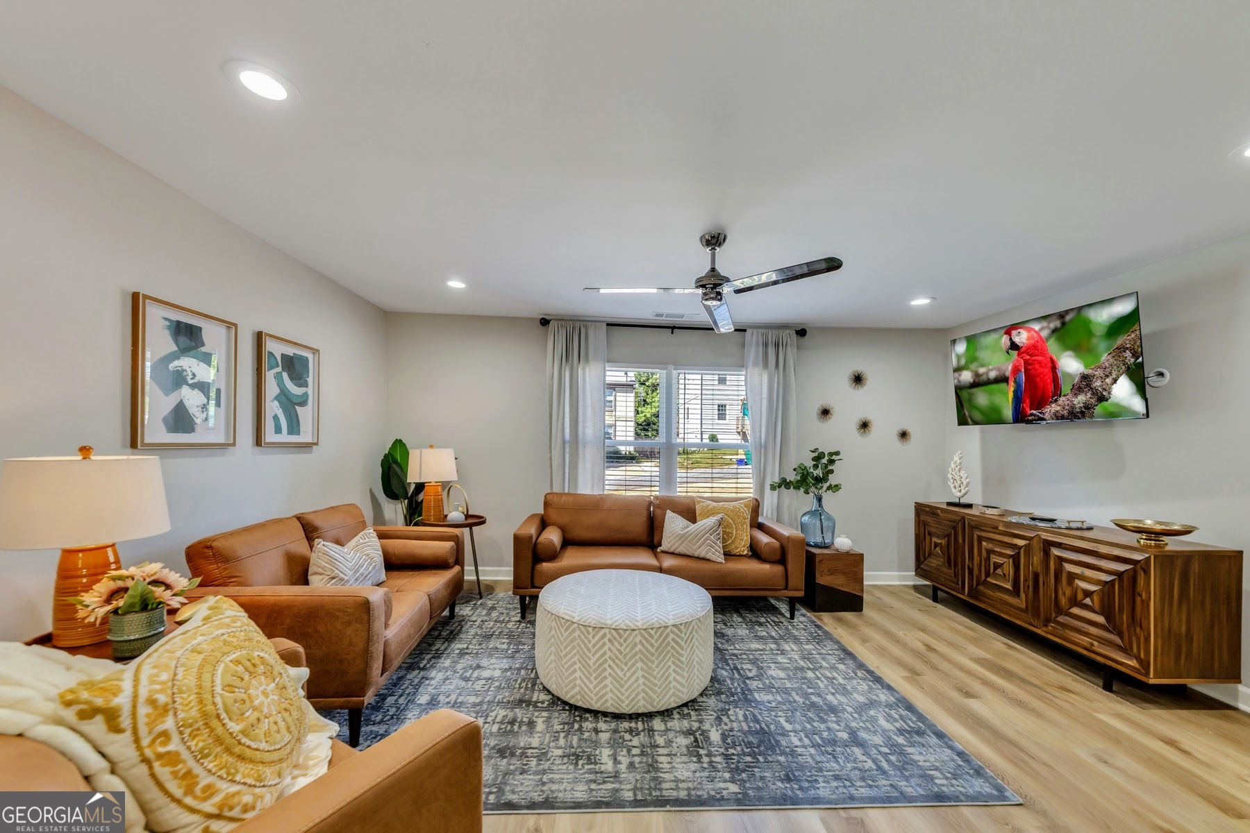 a living room with furniture and a flat screen tv