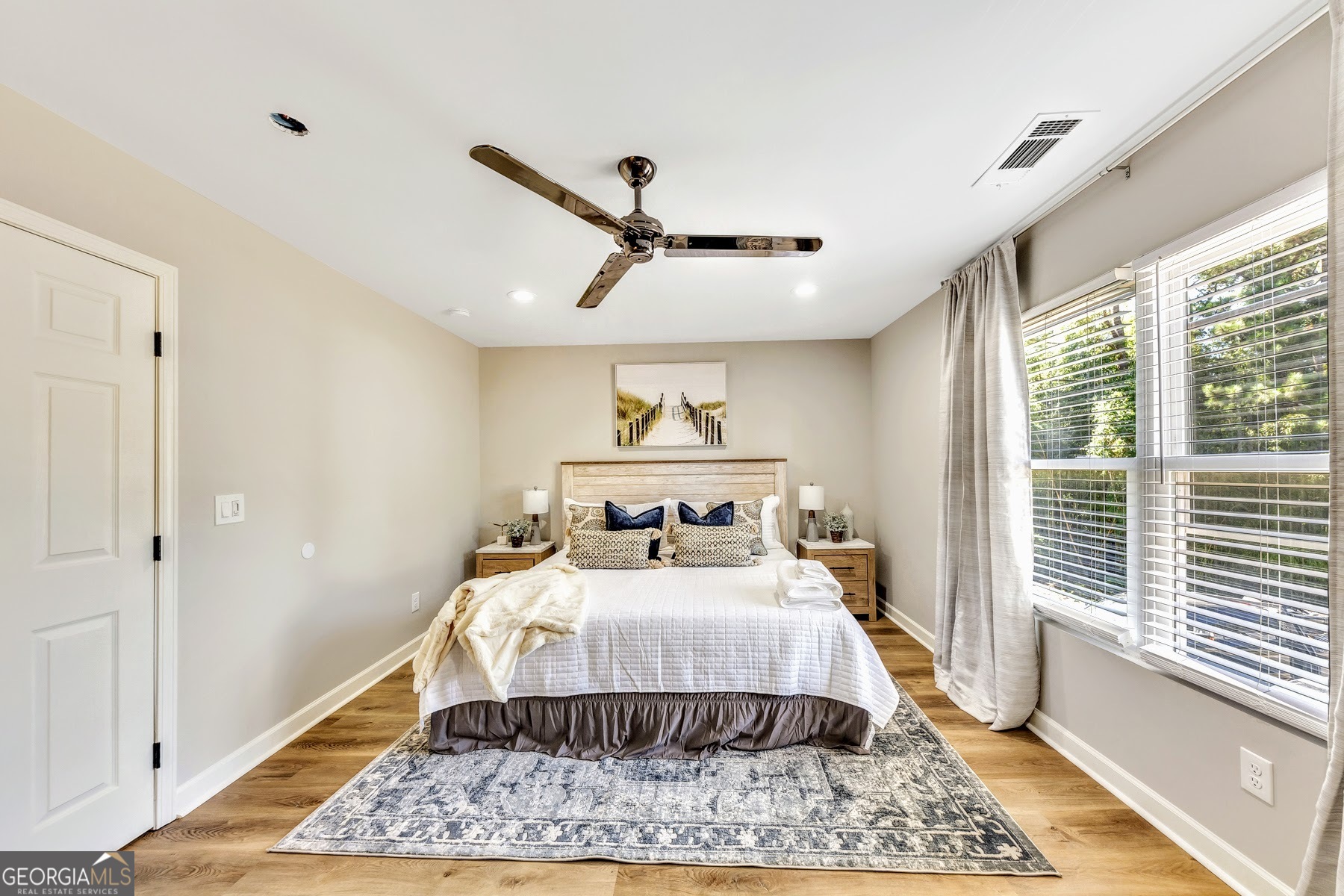 1018 Falling Valley Court Southeast Smyrna, GA 30080 - Photo 18 of 25 a bedroom with a bed and wooden floor