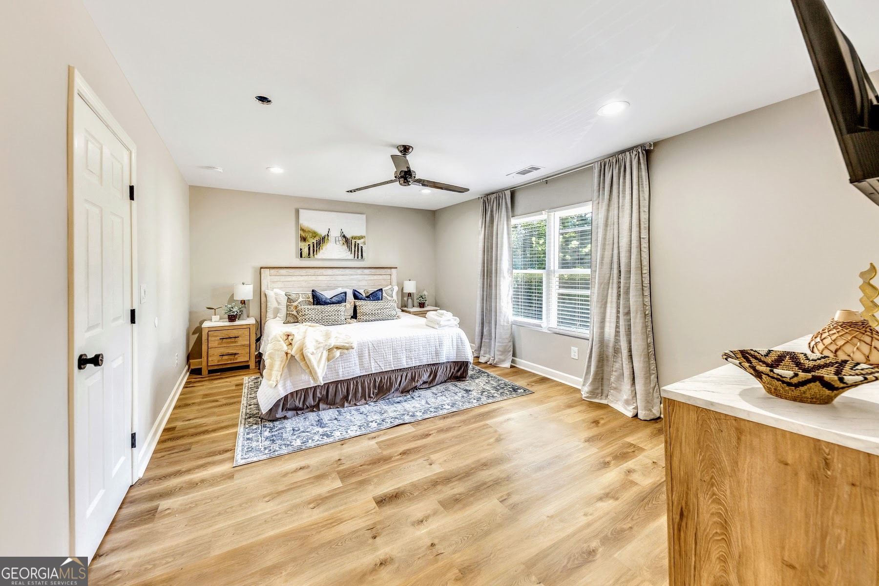 1018 Falling Valley Court Southeast Smyrna, GA 30080 - Photo 23 of 25 a bedroom with a bed and wooden floor