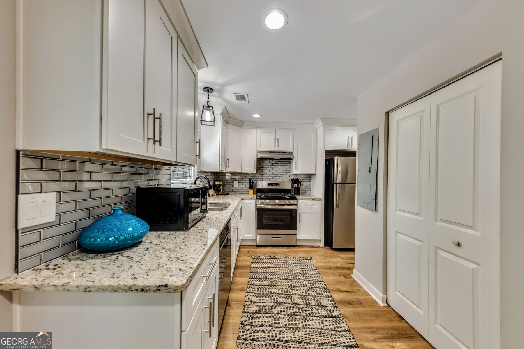 1018 Falling Valley Court Southeast Smyrna, GA 30080 - Photo 5 of 25 a kitchen with stainless steel appliances granite countertop a refrigerator a stove and a sink