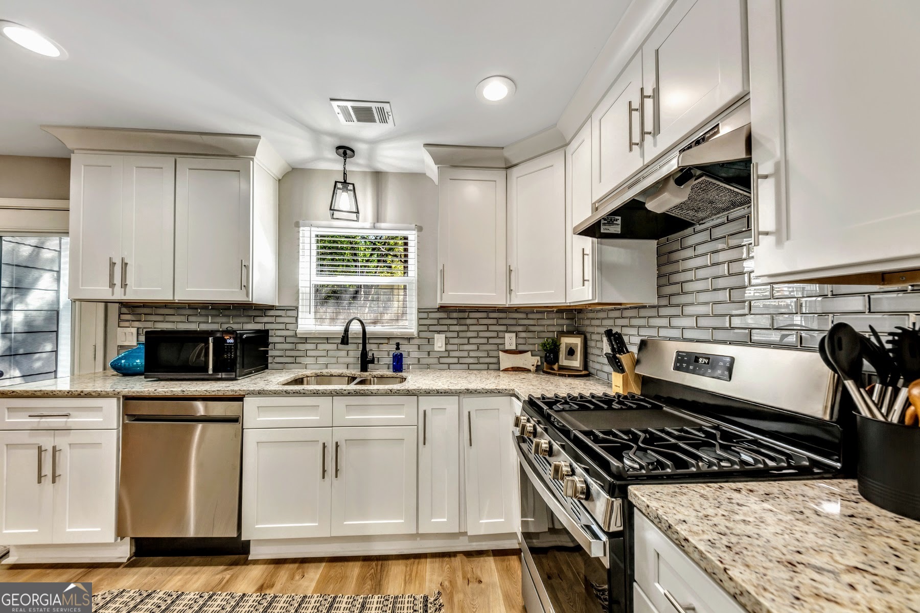1018 Falling Valley Court Southeast Smyrna, GA 30080 - Photo 6 of 25 a kitchen with white cabinets and appliances