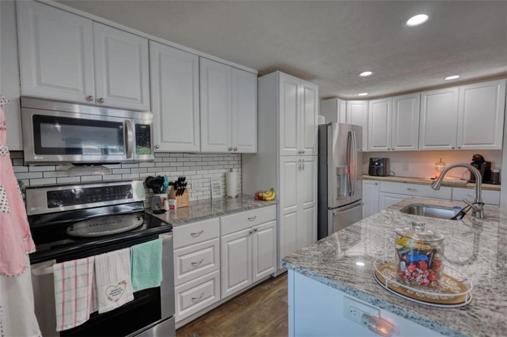 89 Miss Sarah Road Monticello, GA 31064 - Photo 26 of 77 a kitchen with stainless steel appliances granite countertop a sink and cabinets