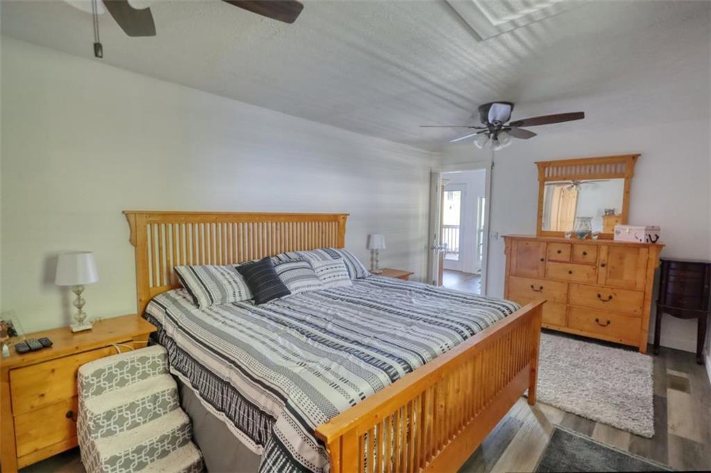 89 Miss Sarah Road Monticello, GA 31064 - Photo 38 of 77 a bedroom with a bed and dresser with mirror