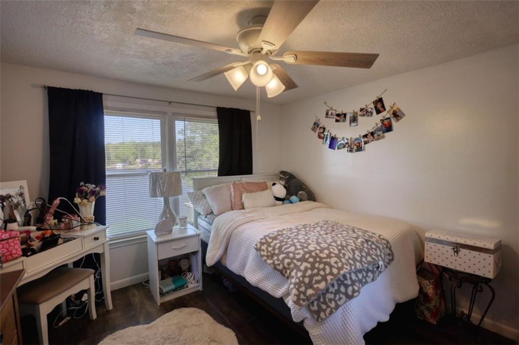 89 Miss Sarah Road Monticello, GA 31064 - Photo 48 of 77 a bedroom with a bed and a chandelier