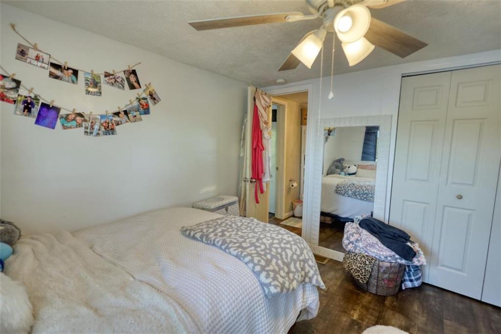 89 Miss Sarah Road Monticello, GA 31064 - Photo 49 of 77 a bedroom with a bed and a chandelier