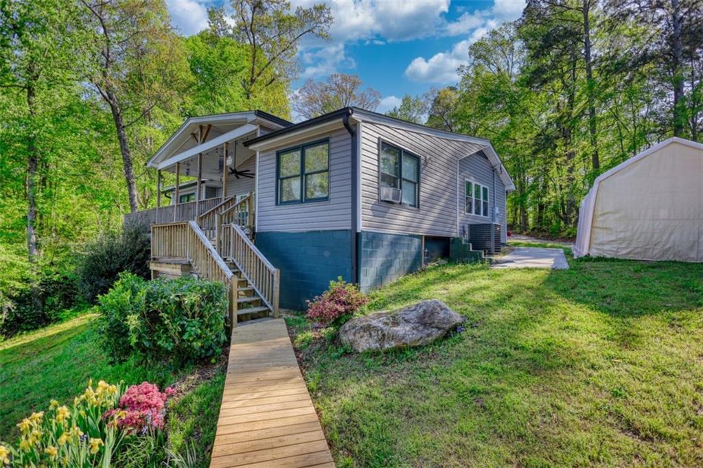 89 Miss Sarah Road Monticello, GA 31064 - Photo 60 of 77 a front view of a house with a yard and a garden