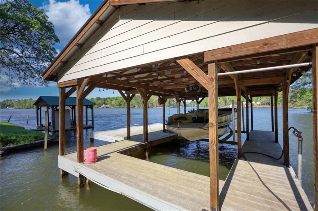 89 Miss Sarah Road Monticello, GA 31064 - Photo 65 of 77 a view of a patio with table and chairs under an umbrella with a barbeque