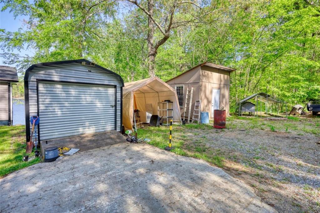 89 Miss Sarah Road Monticello, GA 31064 - Photo 72 of 77 a view of a house with a yard and large tree