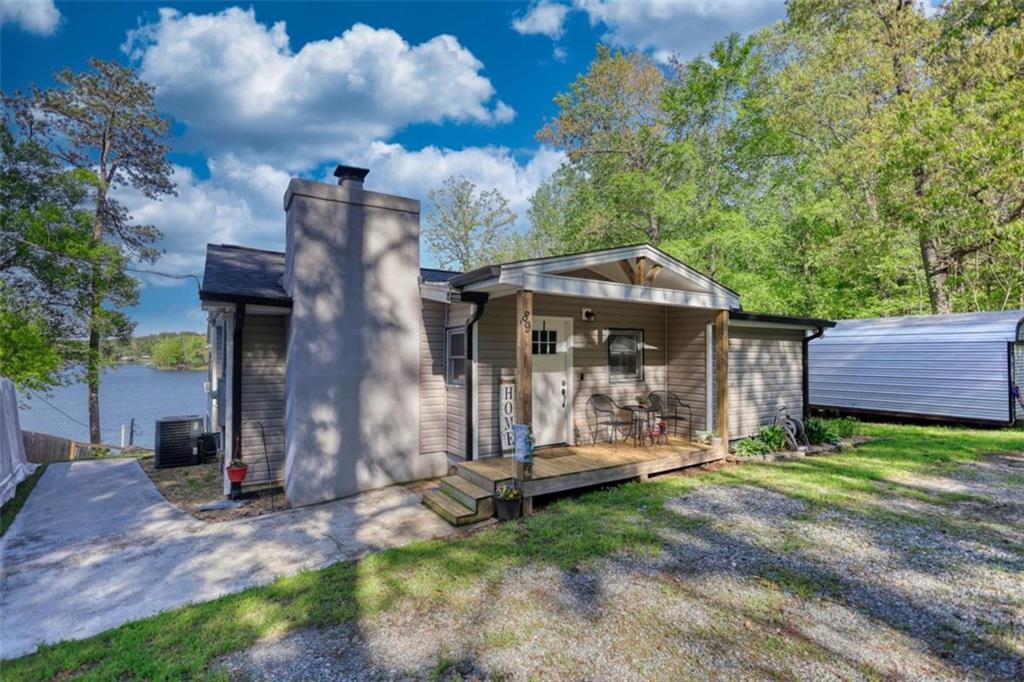 89 Miss Sarah Road Monticello, GA 31064 - Photo 76 of 77 a view of a house with a small yard and a large tree