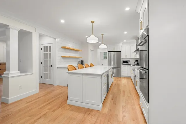 a view of a kitchen with cabinets and wooden floor