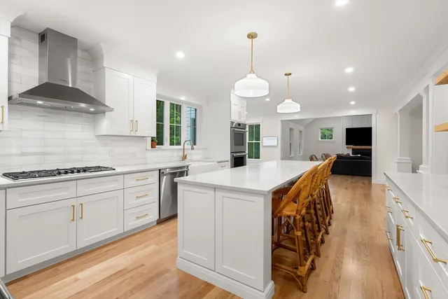 a kitchen with stainless steel appliances granite countertop a stove and a sink