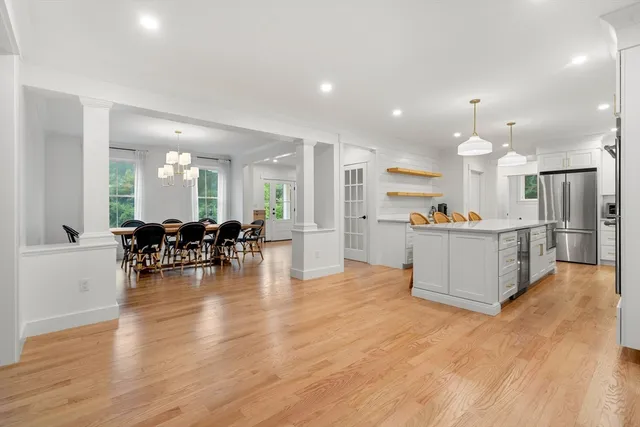 an open kitchen with white cabinets and stainless steel appliances