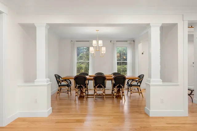 a dining room with furniture window and wooden floor