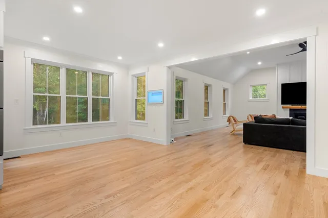 a view of a kitchen with wooden floor and a window