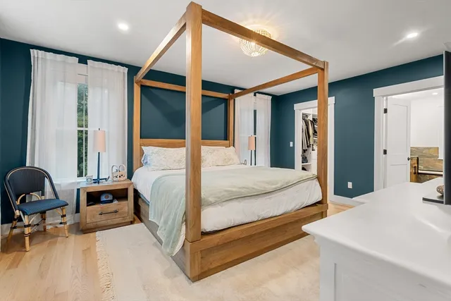 a bedroom with a bed and a chair